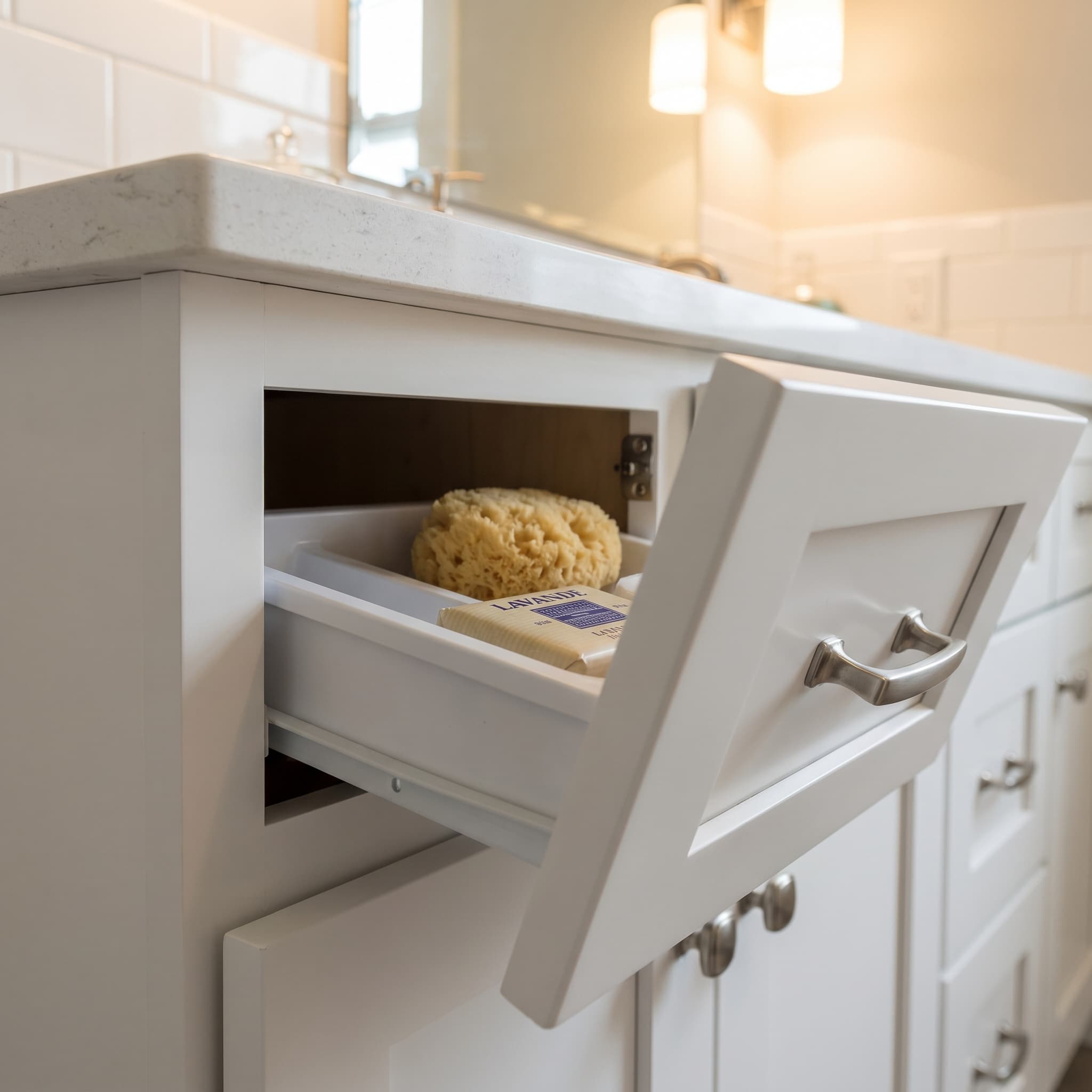 Tilt-out sink-front tray