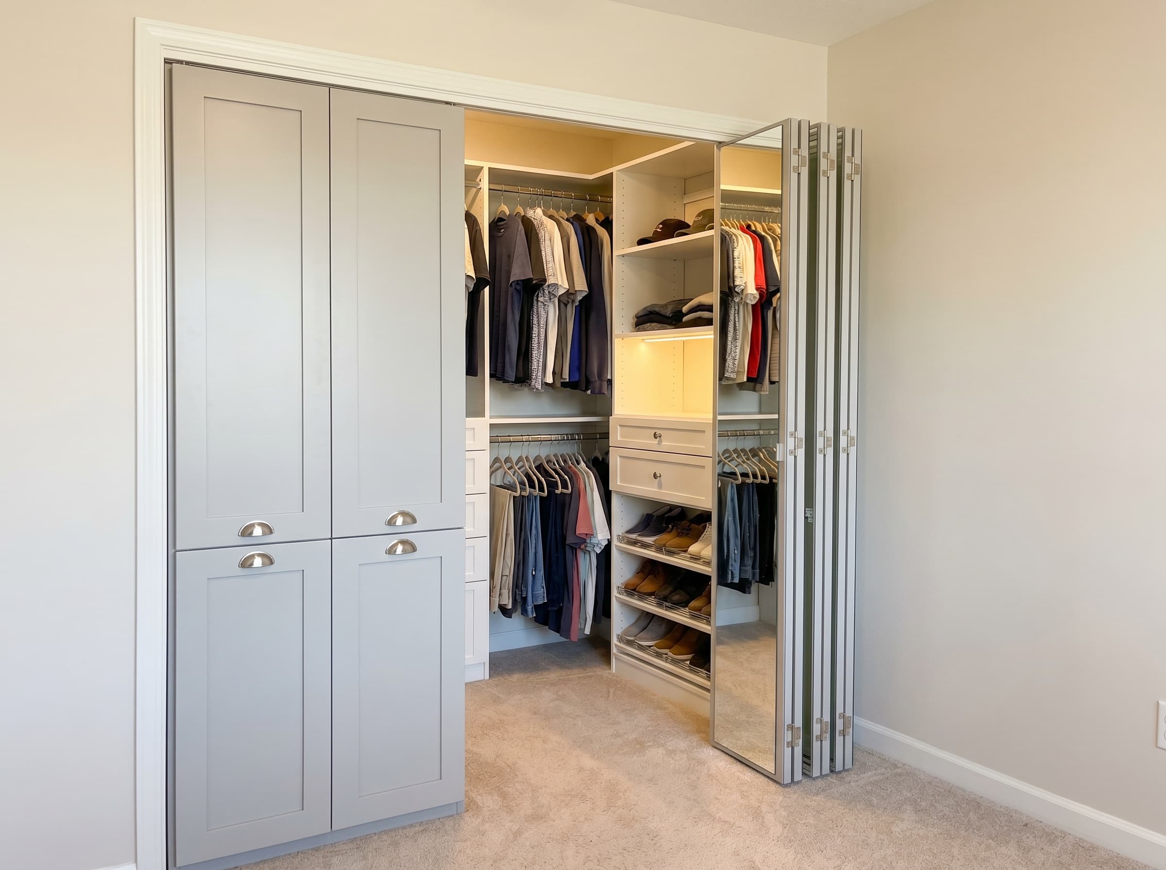 Smyrna, GA · Reach-in with light gray shaker bifold doors and mirrored fronts.