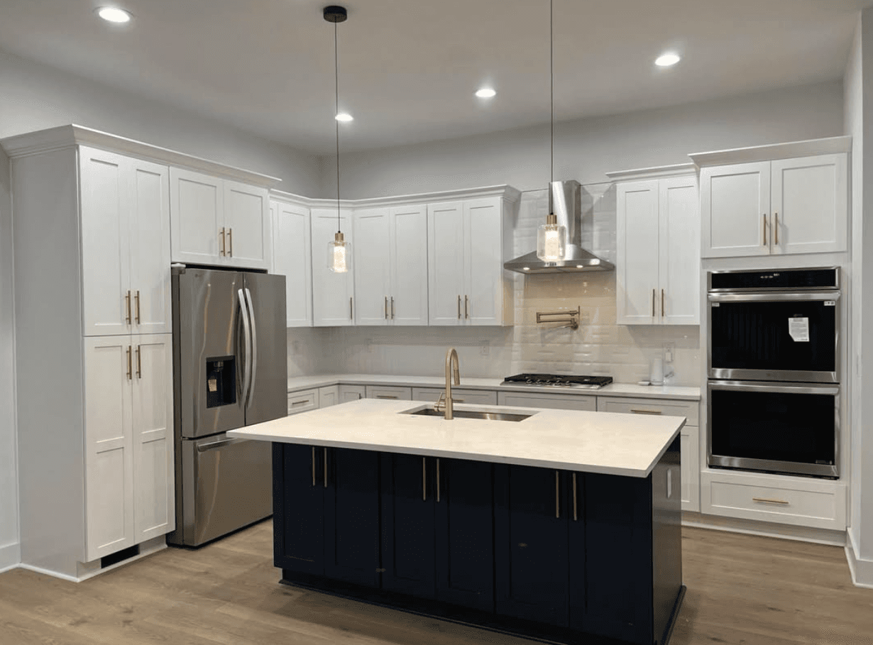 Suwanee, GA · Two-tone with navy island, white perimeter, and brass faucet.
