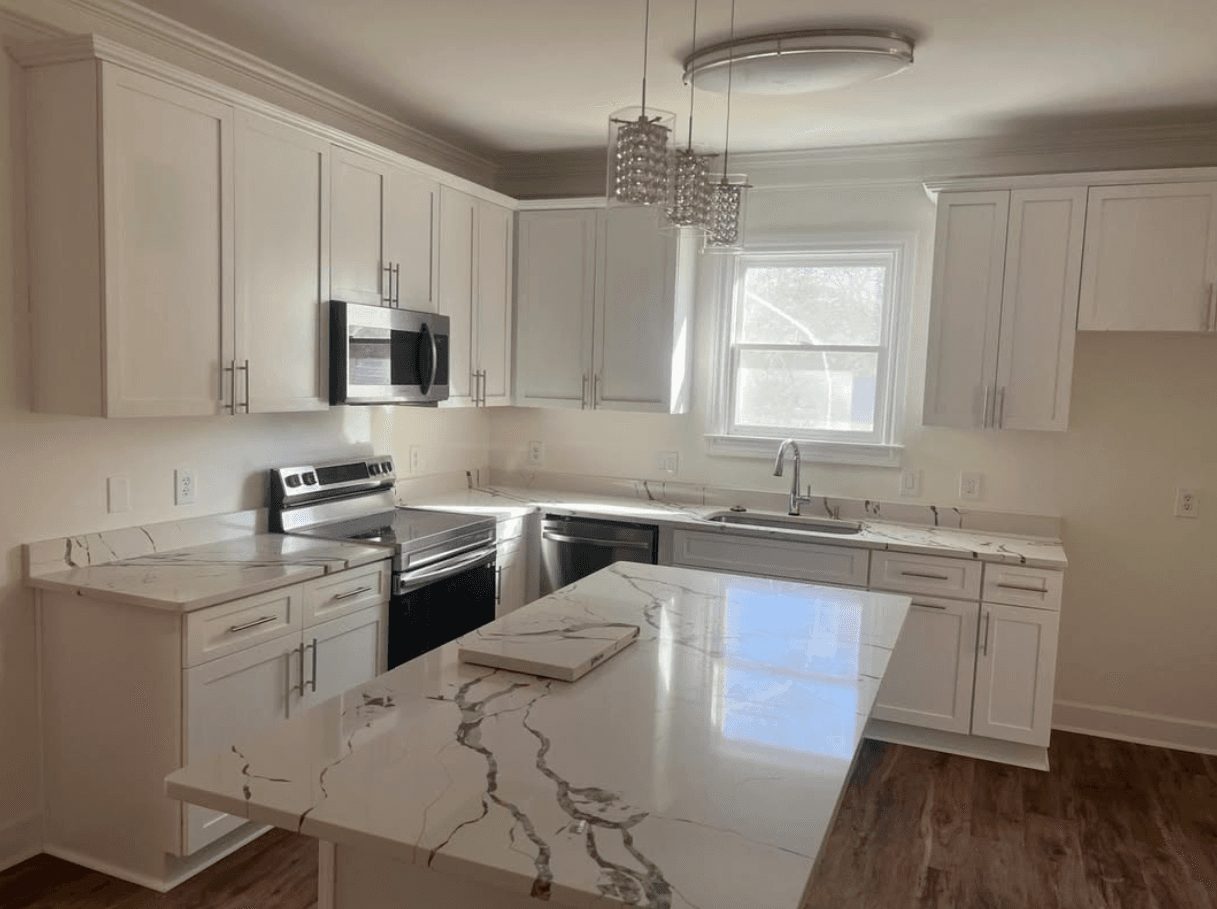 Norcross, GA · White shaker with painted dark island and brass hardware.