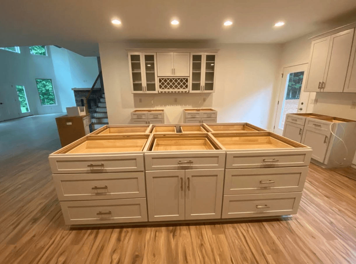 Lilburn, GA · White kitchen with custom hood and stained range backdrop.