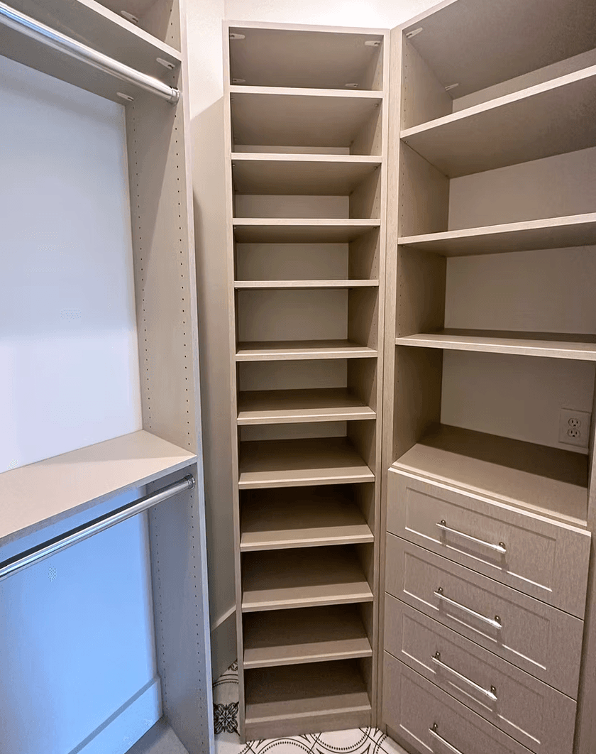 Roswell, GA · Greige corner closet tower with open shelving and drawers.