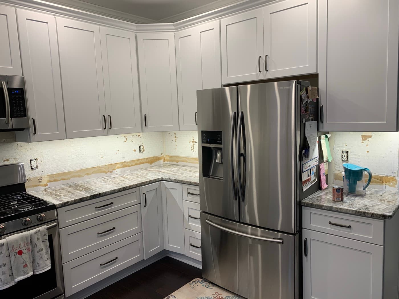 Johns Creek, GA · White kitchen with subway backsplash and stainless appliances.