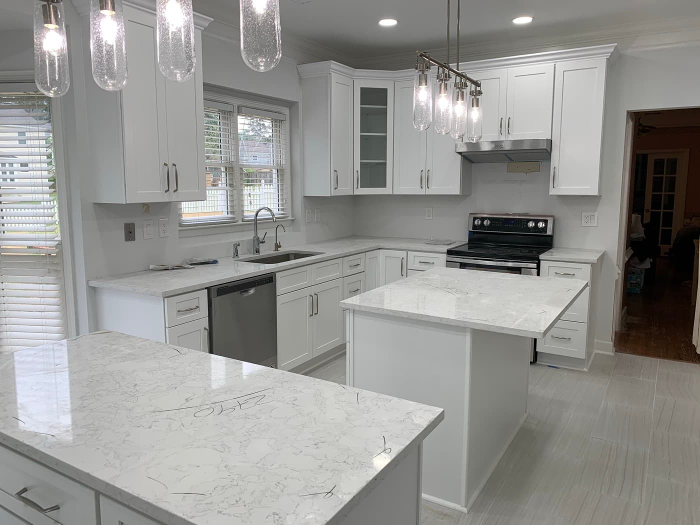Acworth, GA · Two-tone kitchen with painted island and brass hardware.