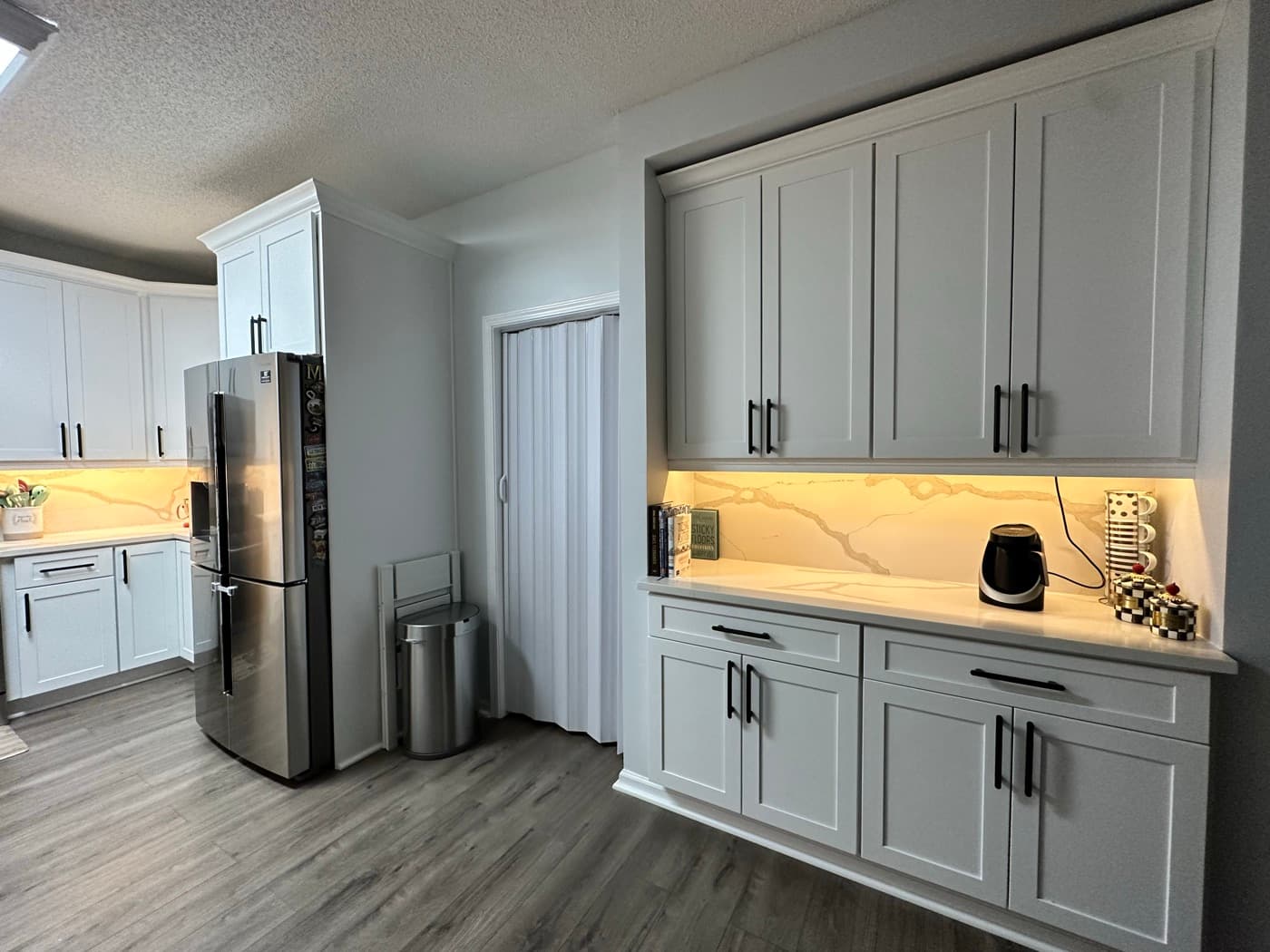 Buford, GA · Custom kitchen cabinets with quartz tops and pendant lighting.