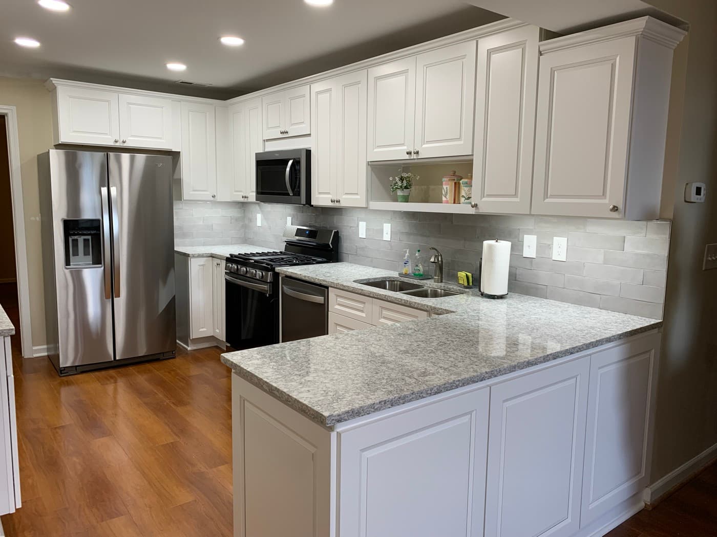 Brookhaven, GA · White shaker kitchen with quartz counters and island.