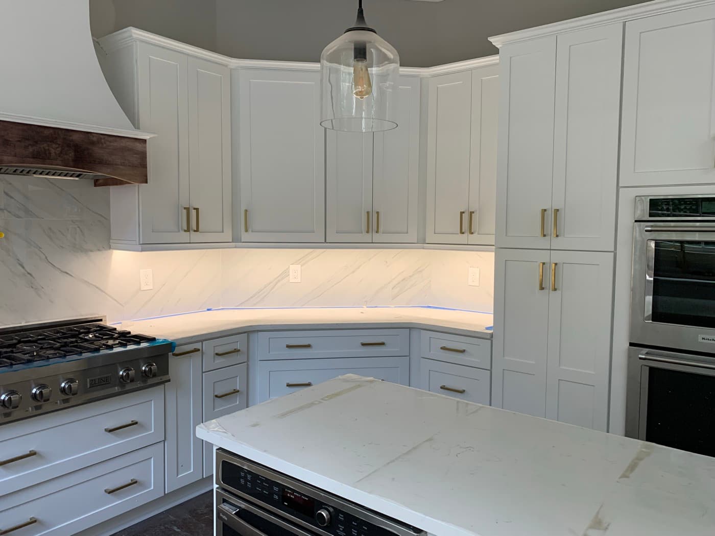 Dunwoody, GA · Two-tone kitchen with painted island and brass hardware.
