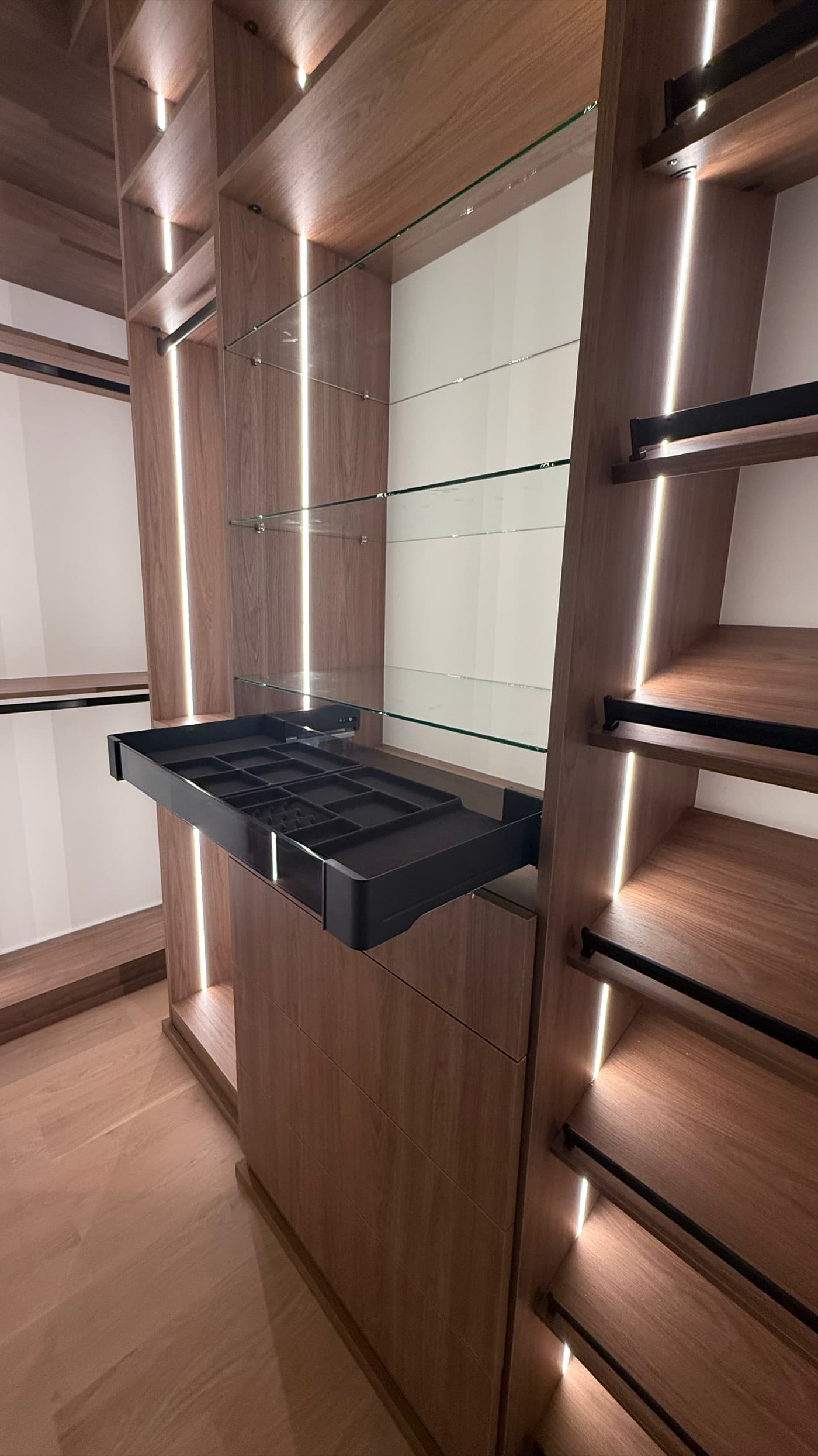 Sandy Springs, GA · Reach-in closet with adjustable shelving and drawer bank.