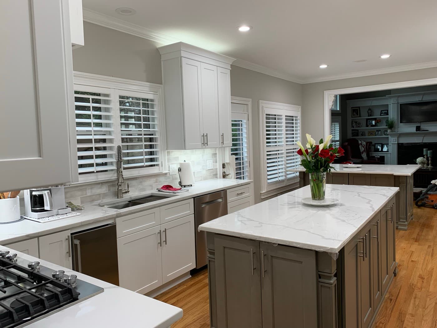 Peachtree Corners, GA · Custom kitchen cabinets with quartz tops and pendant lighting.