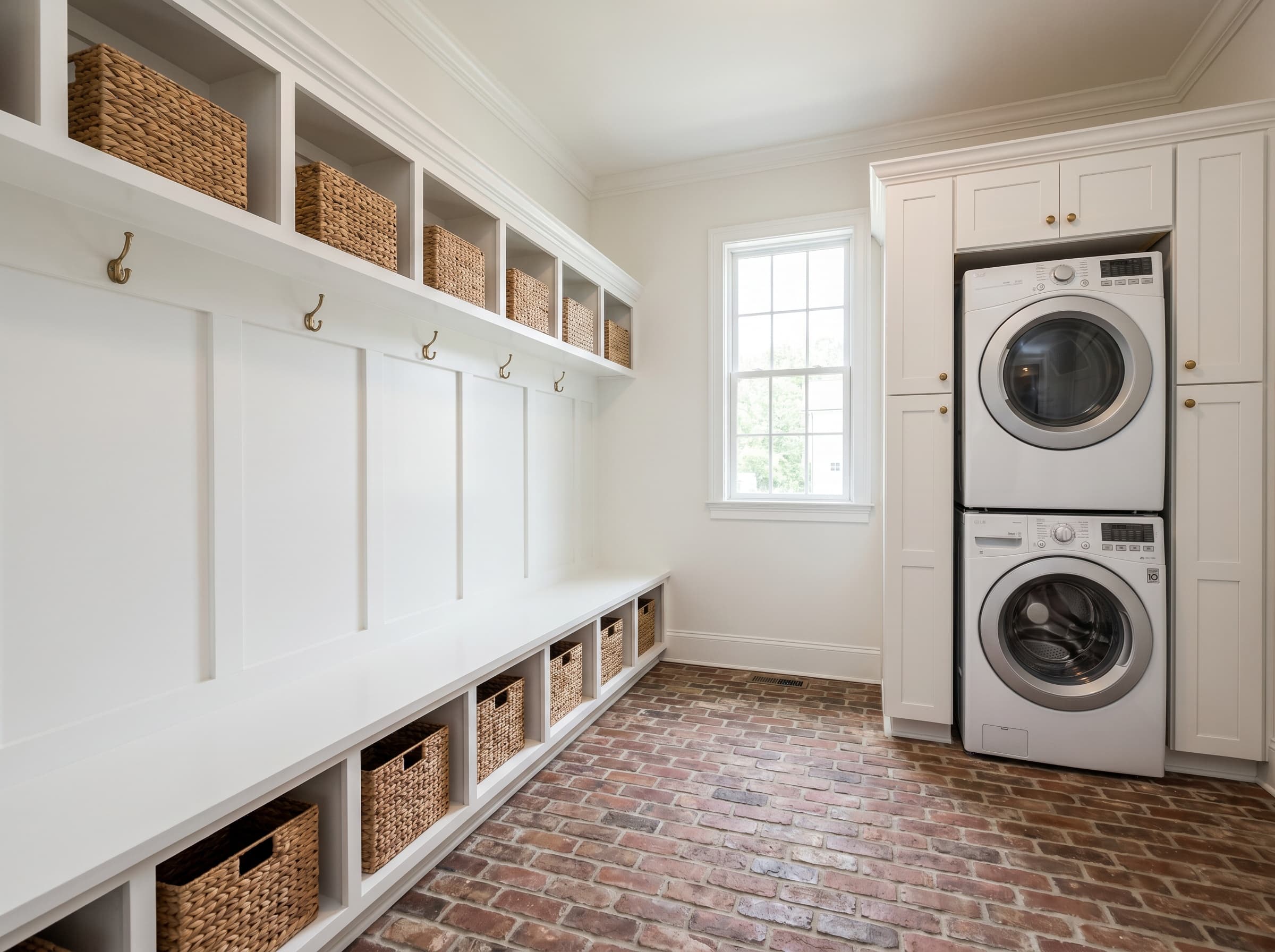 Roswell, GA · Large mudroom with bench wall and stacked laundry corner.