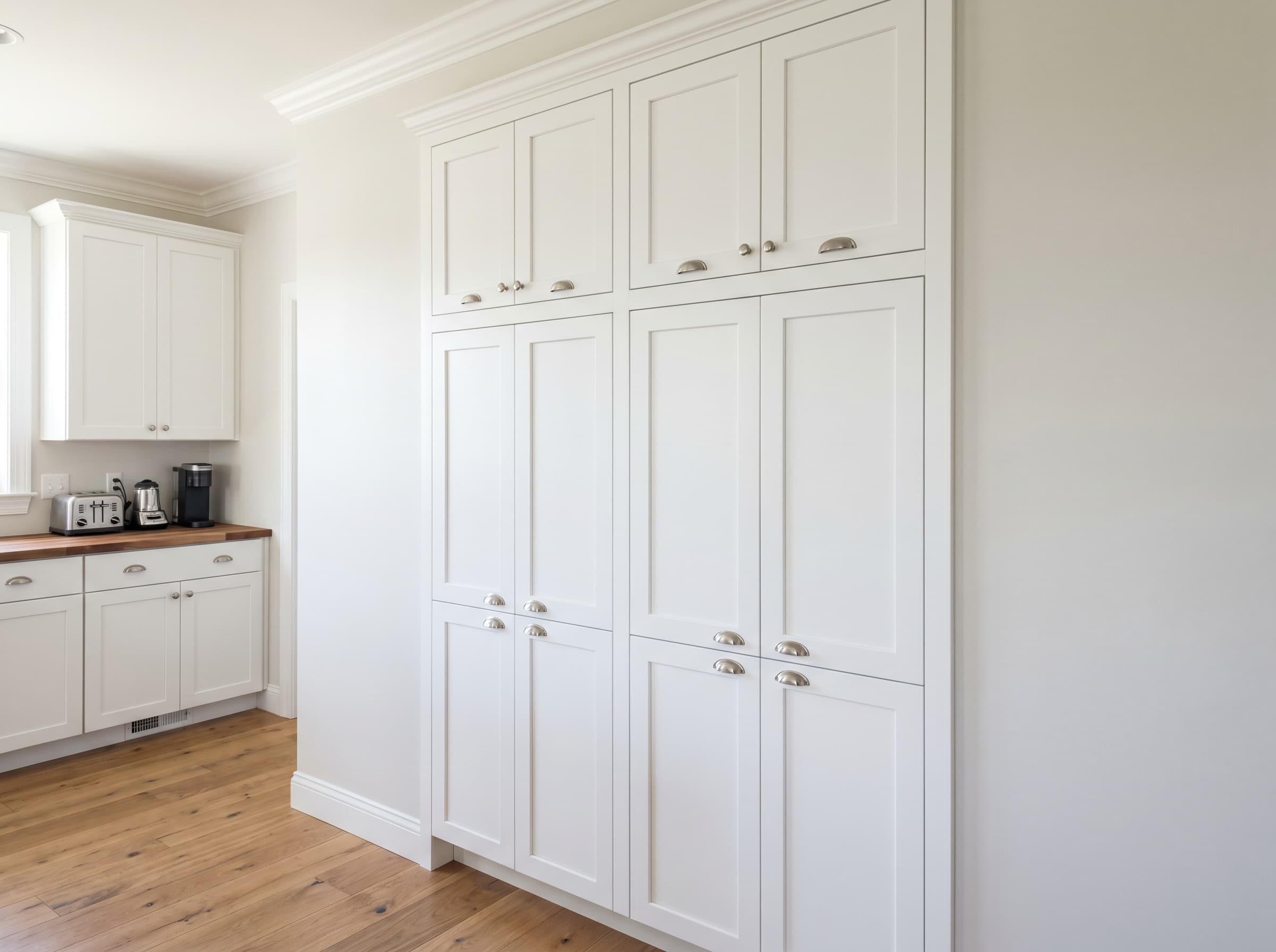 Smyrna, GA · Tall white shaker built-in pantry with roll-out drawers.